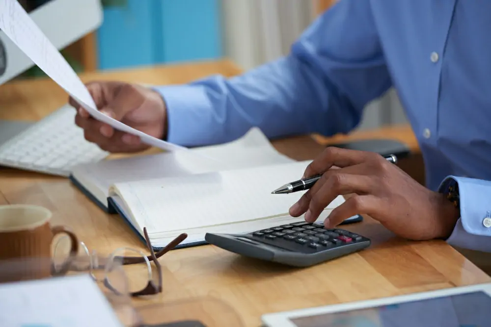man with documents anfd calculator
